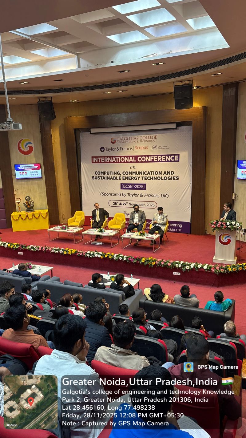 I3CSET‑2025 — Dais panel with Mr. Kapil Kumar and chief guests addressing a packed auditorium, Greater Noida (28 Nov 2025).