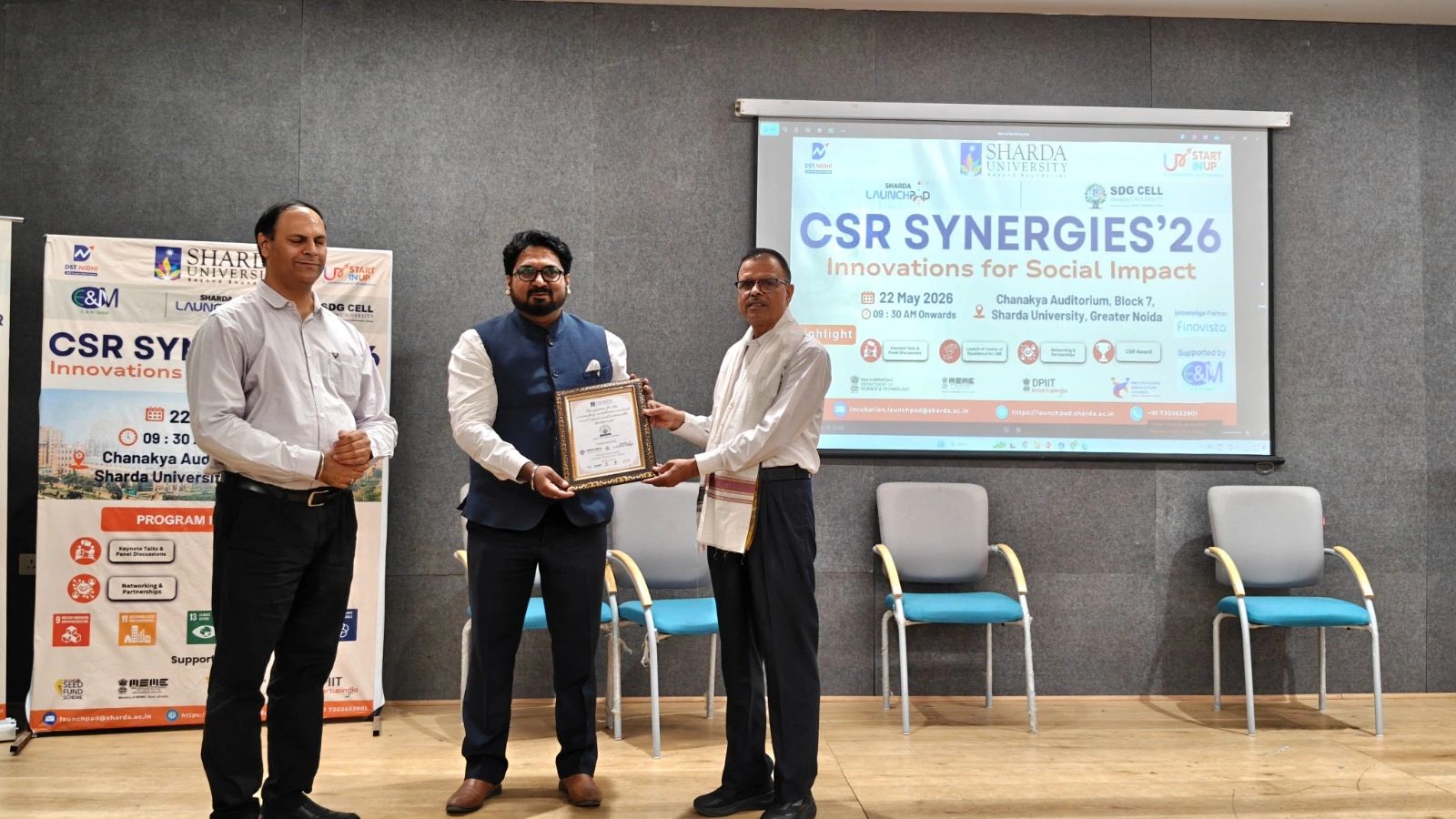 Sharda University — CSR Synergies'26 'Innovations for Social Impact' (22 May 2026, Chanakya Auditorium, Block 7, Greater Noida): Mr. Kapil Kumar felicitated on stage at the launch of the Centre of Excellence for CSR, with Finovista as knowledge partner.